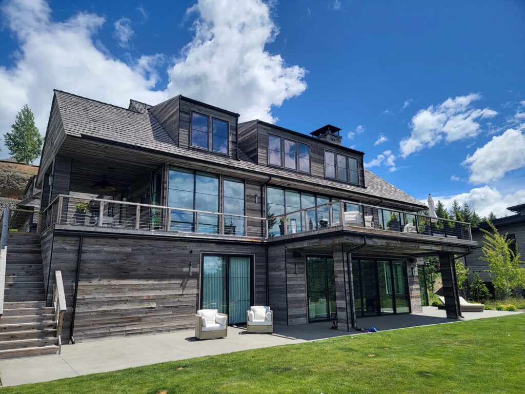 Residential window washing, moss removal, and pressure washing for high gables in Hayden Lake, ID by Bullseye Wash Systems, restoring the beauty of home exteriors.