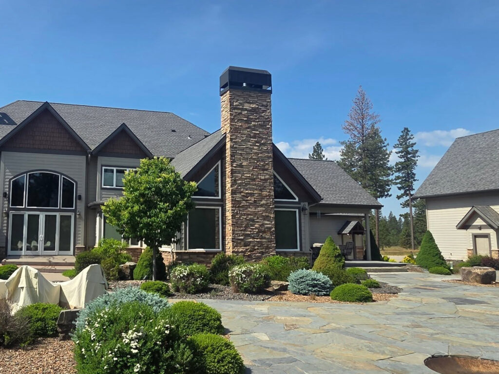 Pressure washing of brick and siding at a high-end custom home in Spokane, WA by Bullseye Wash Systems.
