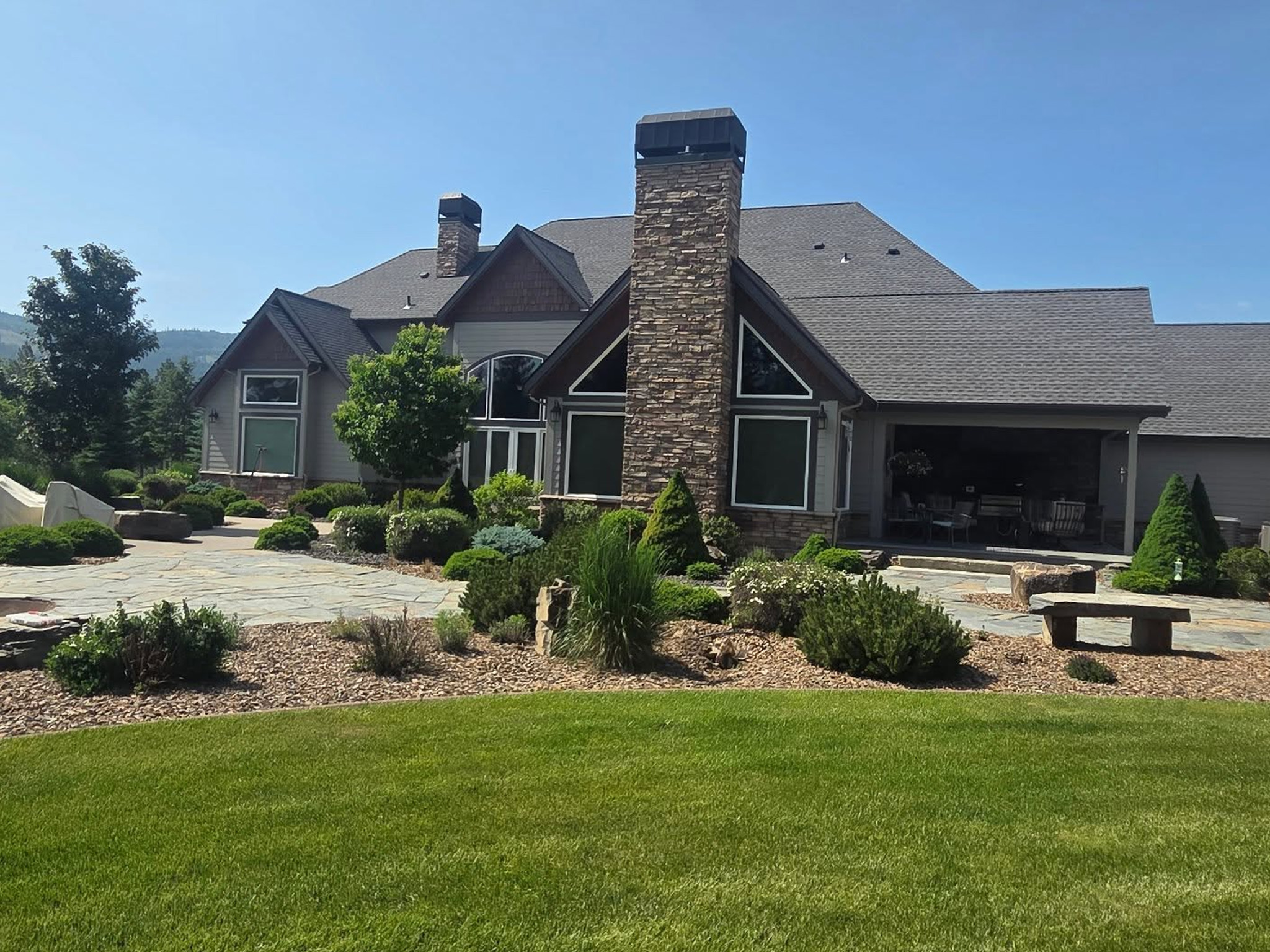 Window washing for a high-end custom home in Spokane, WA by Bullseye Wash Systems, ensuring streak-free windows for clear views.