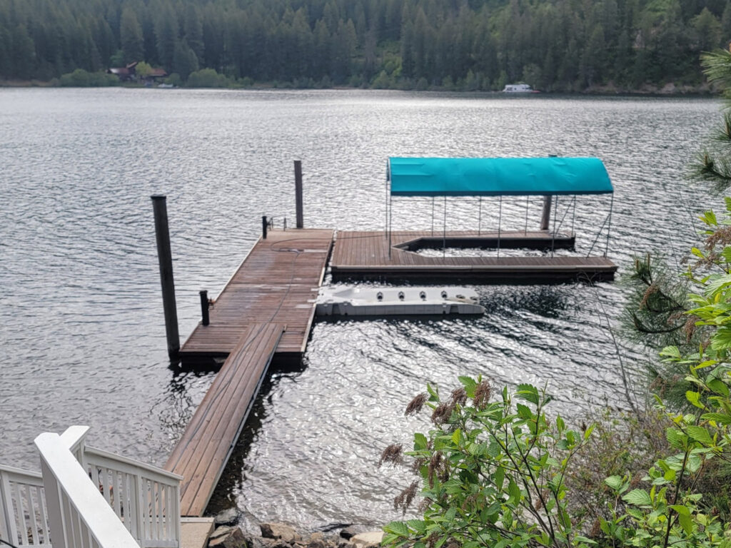 Soft washing of a roof in Colbert, WA to remove moss and debris, provided by Bullseye Wash Systems.