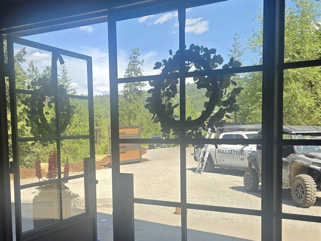 Roof soft washing service in Sagle, ID for removing pine needles and debris from a home’s roof, provided by Bullseye Wash Systems.