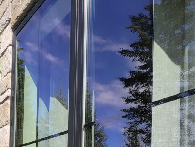 Soft washing services for a luxury home in Rathdrum, ID with views of Vanishing Prairie, provided by Bullseye Wash Systems.