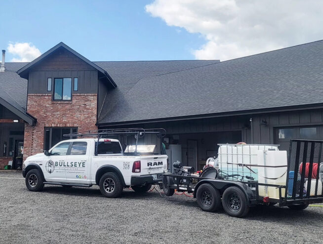 High gabled windows being washed by Bullseye Wash Systems at a large home in Post Falls, ID.