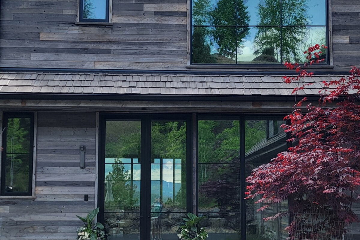 Window washing combined with pressure washing for a luxury custom home in Coeur d'Alene, ID by Bullseye Wash Systems, offering streak-free windows and clean exteriors.