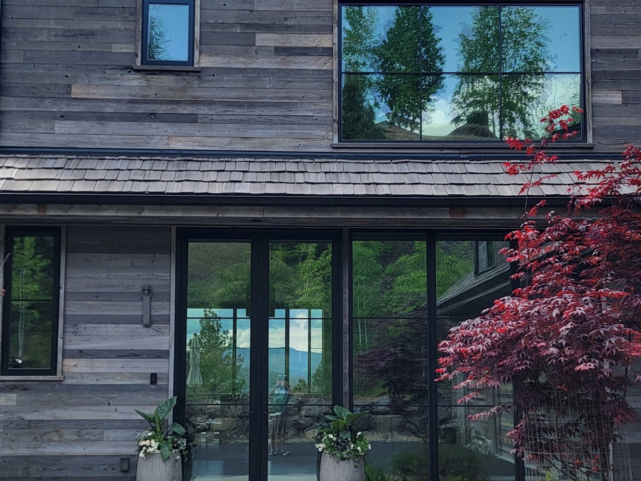 Window washing combined with pressure washing for a luxury custom home in Coeur d'Alene, ID by Bullseye Wash Systems, offering streak-free windows and clean exteriors.