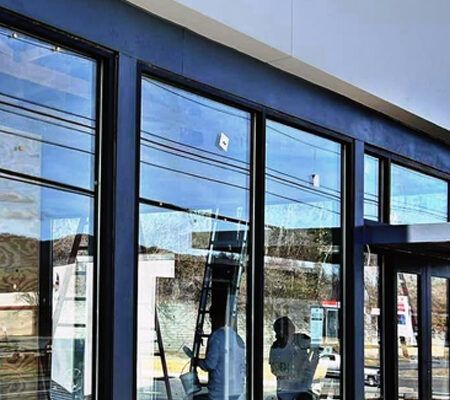 Commercial window cleaning on a modern business exterior in Coeur d'Alene ID by Bullseye Wash Systems