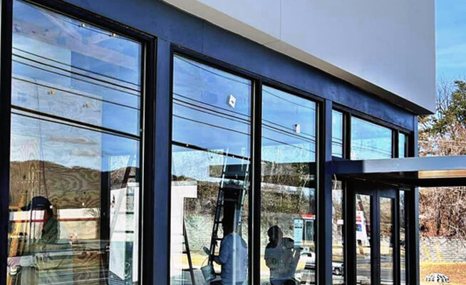 Commercial window cleaning on a modern business exterior in Coeur d'Alene ID by Bullseye Wash Systems