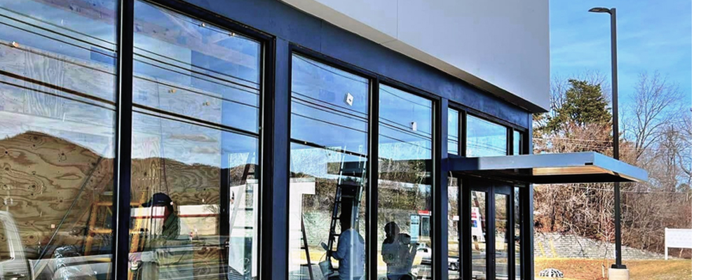 Commercial window cleaning on a modern business exterior in Coeur d'Alene ID by Bullseye Wash Systems